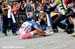 Julien Absalon collapsed on the ground with his wife and son watching 		CREDITS:  		TITLE: La Bresse World Cup 		COPYRIGHT: Rob Jones/www.canadiancyclist.com 2012© All rights retained - no use permitted without prior, written permission