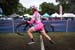 Elle Anderson flies through the barriers on the first lap. The California Giant-Specialized team wears pink during October for Breast Cancer Awareness Month. 		CREDITS:  		TITLE:  		COPYRIGHT: Meg McMahon