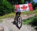 Emily Batty climbs past the flag erected by her family 		CREDITS:  		TITLE: 2013 MTB Nationals 		COPYRIGHT: Rob Jones/www.canadiancyclist.com 2013 -copyright -All rights retained - no use permitted without prior, written permission