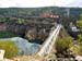 Crossing a huge hydro dam before the 2nd climb 		CREDITS:  		TITLE: 2014 Road World Championships Ponferrada Spain 		COPYRIGHT: Rob Jones/www.canadiancyclist.com 2014 -copyright -All rights retained - no use permitted without prior, written permission