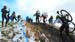 Racers in the Open Mens field cresting the challenging run-up to the cheers of bundled up spectators. 		CREDITS:  		TITLE:  		COPYRIGHT: