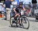 Sandra Walter comes into the pit with a flat rear tire at the start of the last lap 		CREDITS:  		TITLE: 2019 Canada Cup, Bear Mtn 		COPYRIGHT: Rob Jones/www.canadiancyclist.com 2019 -copyright -All rights retained - no use permitted without prior, writte